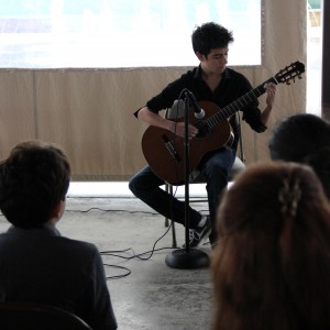 Coppell High School sophomore Juan Vegas plays his guitar for the crowd at the Coppell Arts Festival on Oct. 31. Vegas enjoys music and is currently taking AP Music Theory course at CHS. Photo by Ayoung Jo. 