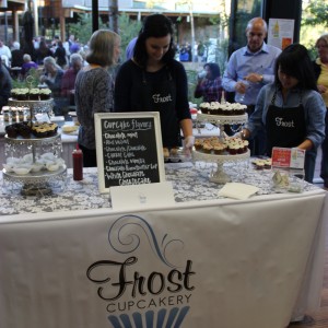 Frost Cupcakery lays out its display of miniature cupcakes on the table at the Taste of Coppell on Nov. 8 at the Senior and Community Center. Frost Cupcakery received the Golden Fork Award, and it’s White Chocolate Cheesecake was named the Best Sweet Treat. Photo by Ayoung Jo.