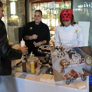 A resident asks the chefs from Zenzero Kitchen about their array of samples including apple bread pudding and angus beef sliders. Zenzero Kitchen was one of the three recipients of the Top Taste award winners. Photo by Ayoung Jo. 