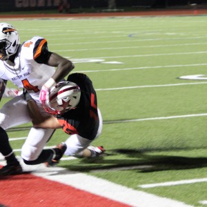 Coppell High School senior defensive back Mason Junker tackles a Haltom player and goes out of bounds on Buddy Echols Field. The Buffalos lost to the Cowboys on Friday night 44-6. Photo by Megan Winkle