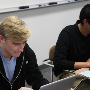 Coppell High School seniors Harrison Haas and Daniel Gonzales work individually in AP Economics teacher Miranda Portteus’ class on Oct. 30. Haas and Gonzales founded Tutor Me Texas, a company that employs CHS students as tutors for students in Coppell. Photo by Mallorie Munoz. 
