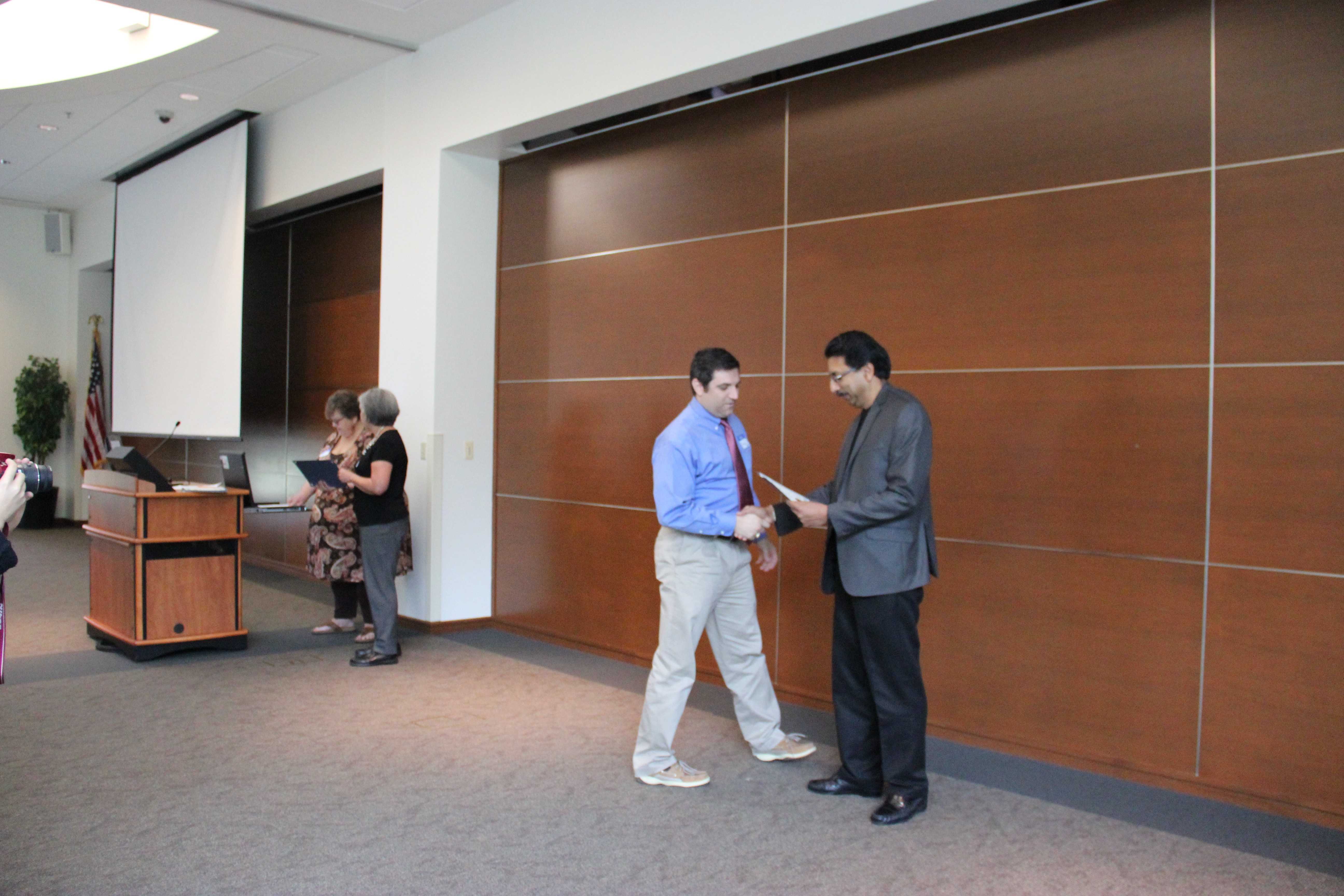 Coppell High School engineering teacher Grant Garner receives recognition for the University of Texas at Dallas 2015 Inspiration Award by motivating and inspiring future computer scientists. This award was presented by UTD Computer Science department head Dr. Gopal Gupta.