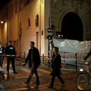 As people make their way home after work on Thursday, Nov. 19, 2015, only one police officer remains to guard the Bataclan theater where the largest number of vicitms were killed in Friday's attack. (Carolyn Cole/Los Angeles Times/TNS)