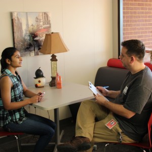 Coppell High School Social studies teacher Chris Caussey listens to freshman Manasi Ramadurgum at TEDxYouth talk auditions Wednesday after school outside of room B216. Ramadurgum has had experiences that have resulted from religious ignorance and hopes to stress the importance of acceptance through her talk. Photo by Ayoung Jo. 