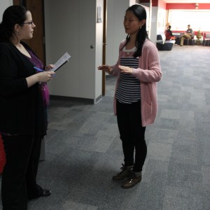 Coppell High School sophomore Sol Hong explains her topic of interest to English teacher Amy Wilkinson at the TEDxYouth talk auditions Wednesday after school outside of social studies teacher Chris Caussey’s room. Hong practices martial arts and would love to share her experience with others in the school. Photo by Ayoung Jo.
