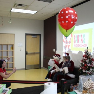 Coppell residents take pictures of their children with Mr. and Mrs.Claus at the Santa’s workshop at the CORE, formerly known as Coppell Aquatic and Recreation Center, on Dec.12. The children told Santa what presents they wished to receive for Christmas and gave him their letters. Photo by Ayoung Jo.