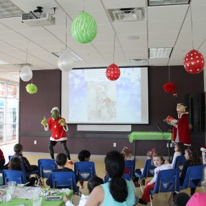 Children gather around to listen to “How the Grinch Stole Christmas!”, a book written by Dr.Seuss, at the Santa’s Workshop at the CORE, formerly known as Coppell Aquatic and Recreation Center, on Dec.12. Cindy Lou Who read the book aloud while the Grinch acted it out for the children. Photo by Ayoung Jo. 