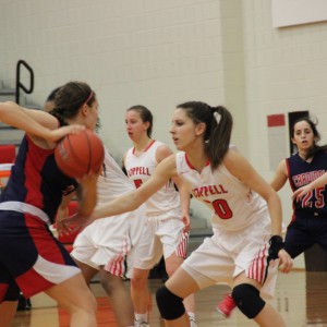 Coppell High School senior Sydney Gainer defends while the John Paul II Cardinals try and score in the first quarter of Friday night’s game in the CHS large gym. The Coppell Cowboys beat John Paul II with a final score of 51-28. Photo by Amanda Hair.