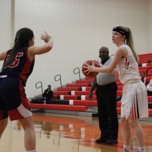  Coppell High School junior Paige Haas throws the ball in after the John Paul II Cardinals knocked the ball out of bounds. Coppell defeated John Paul II with a final score of 51-28 on Friday night’s game in the CHS large gym. Photo by Amanda Hair. 