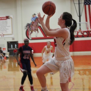 During the beginning of the third quarter of Friday night’s game, Coppell High School senior Kaylie Stayer goes in for a layup to bring the score to 32-20. Coppell kept the lead over John Paul II for the entire game, ending with a final score of 51-28. Photo by Amanda Hair.