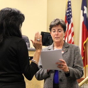  Coppell mayor Karen Hunt congratulates new Coppell City Council board members at Tuesday night's meeting. The council later analyzed neighborhood zoning issues that were brought to attention by Coppell citizens. Photo by Amanda Hair.  