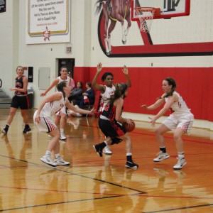Coppell High School juniors Emma Johnson, Chidera Nwaiwu and Abby Meyer guard the opposing Colleyville Heritage Tuesday night at Coppell High School. The Coppell Cowgirls fell to the Colleyville Heritage Panthers 57-28. Photo by Aubrie Sisk.