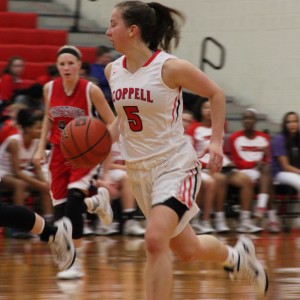 Coppell High School junior shooting guard Emma Johnson dribbles past the defense to later shoot Tuesday night in the Cowgirls 33-32 victory over the Lady Mustangs at Coppell High School.