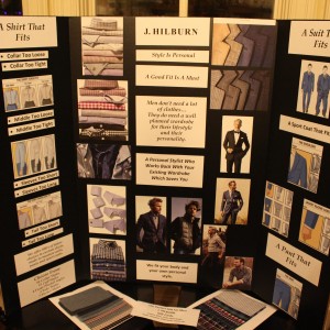 One of many vendors at Laura Swaldi’s annual holiday show, J Hillburn, presents a poster to help shoppers purchase suits. The event was held at Swaldi’s house on Dec.8 and products like jewelry, snacks, and clothing were sold. Photo by Kelly Monaghan.