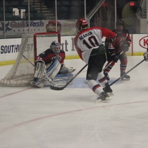 Junior forward James Reaman shoots the puck at the opposing goal in a playoff game against Frisco on Mar. 3, 2015. Coppell lost 1-0, eliminating them from the playoffs. Photo by Kelly Monaghan.