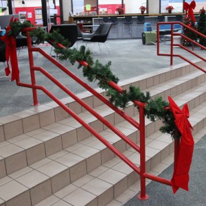 Coppell High School library teachers put up decorations around the staircase railings during the holidays. With Christmas break approaching, the library is spreading cheer and bettering the holidays.