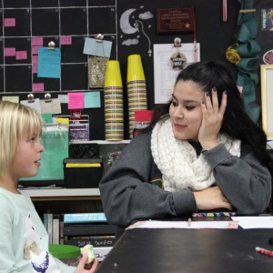 Senior Allysa Garza helps a Cottonwood Creek student write a letter to Santa on Dec. 15 in her English class on Dec. 15. The Cottonwood Creek students were surprised by Santa Claus after writing their letters. Photo by Mallorie Munoz.