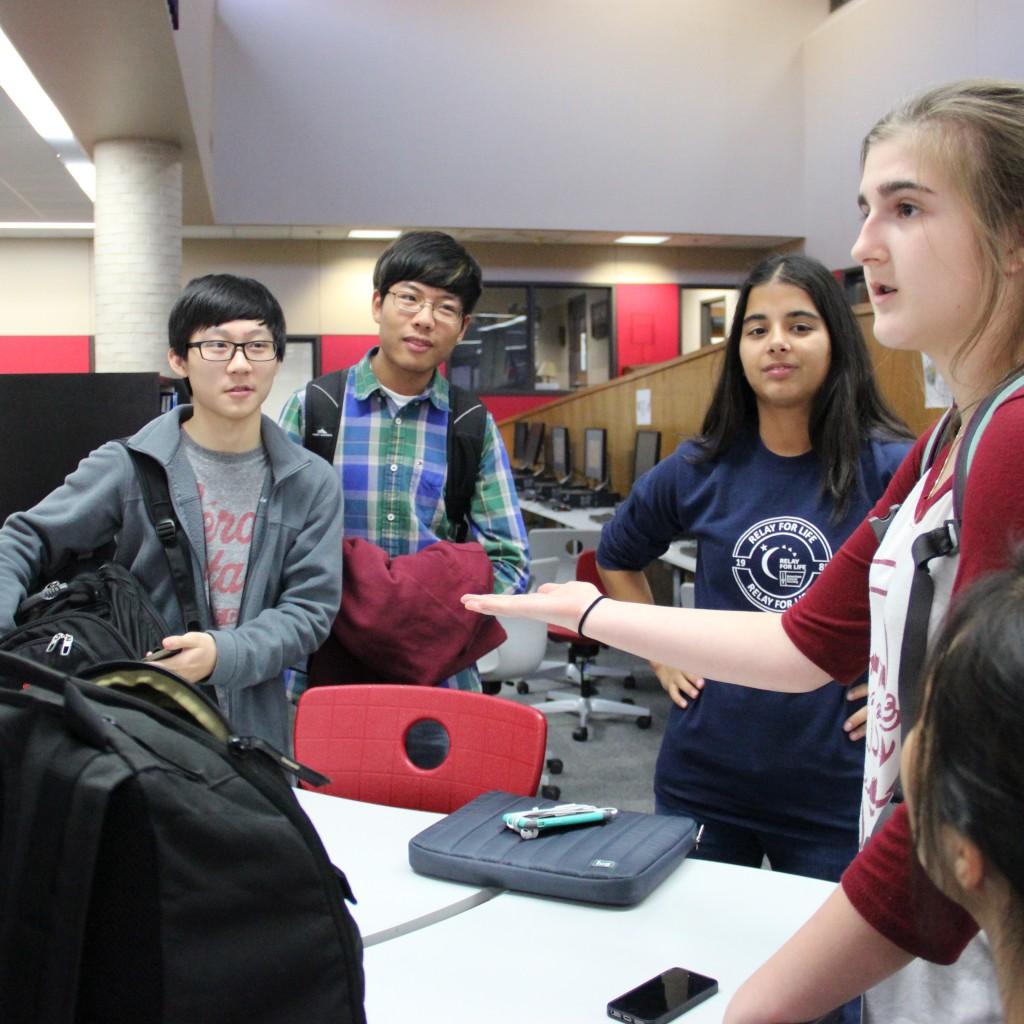 Coppell High School sophomore Georgina Bourbon collects club dues from members of the Coppell Music Chamber club on Dec. 2 at the CHS library. Club dues allow this organization to have end of year parties and food at each of the meetings. Photo by Jennifer Su. 