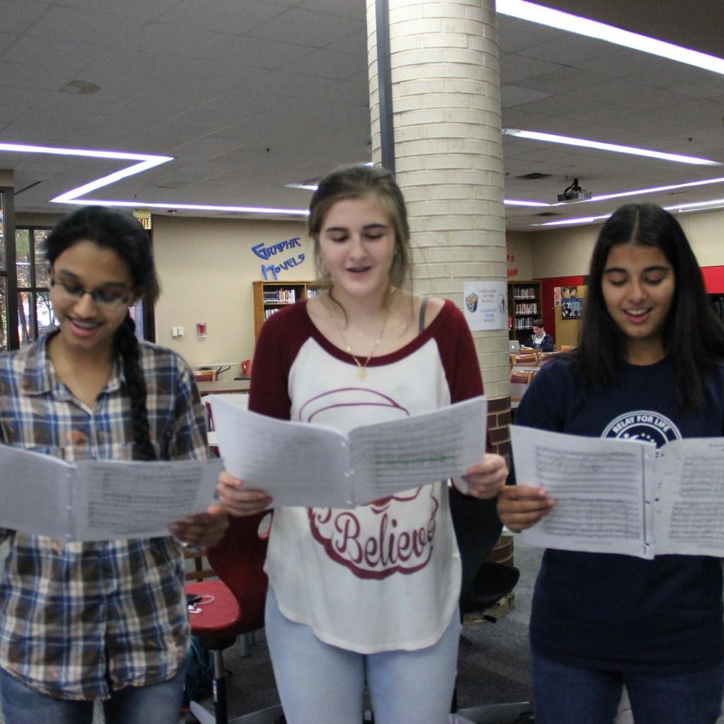 Coppell High School junior Jibi Bijumon, sophomore Georgina Bourbon and sophomore Ashna Pathan practice singing in the library on Dec 3. The next Coppell Music Chamber Club concert is in January at the Coppell Conservatory of Music. Photo by Jennifer Su. 