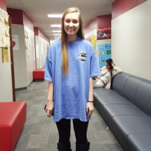 Coppell High School junior Autumn Jones dresses in leggings and an oversized t-shirt, a trend at CHS. Jones is a member of KCBY and is representing the program on her t-shirt. Photo by Jamie Kimbrell.