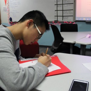 Coppell High School sophomore Vincent Lin writes down his notes about the club during the meeting on Wednesday in room E203. The officers of the newly founded club plan to take the members’ opinions into account as they progress throughout the school year. Photo by Ayoung Jo.